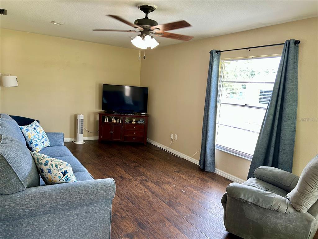 304 Bell Street Wauchula, FL 33873 - Photo 9 of 41 a living room with furniture and a flat screen tv
