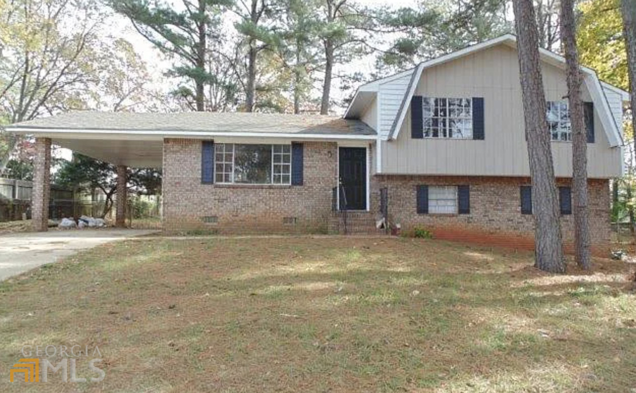 6686 Bedford Road Rex, GA 30273 - Photo 1 of 1 a front view of a house with a yard and garage