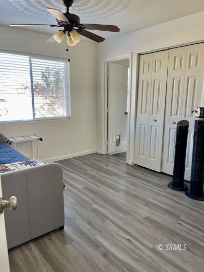 248 North Warner Street Ridgecrest, CA 93555 - Photo 14 of 21 a view of a room with wooden floor and windows