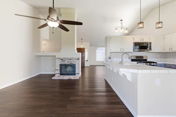 a large kitchen with cabinets a sink and a stove