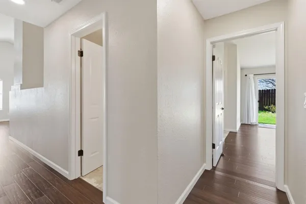 a view of a hallway with wooden floor and interior