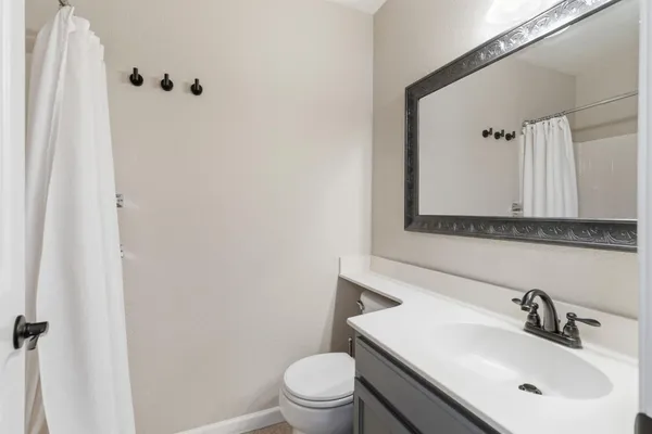 a bathroom with a sink toilet and mirror