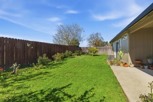 a view of a backyard with sitting area