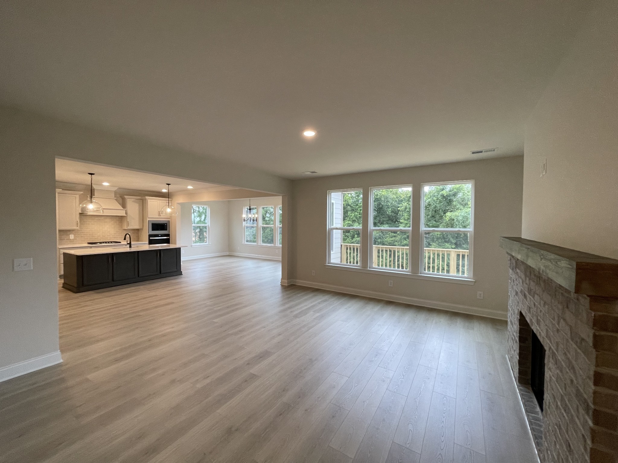 213 Phillips Bend Spring Hill, TN 37174 - Photo 6 of 49 wooden floor in an empty room with a fireplace