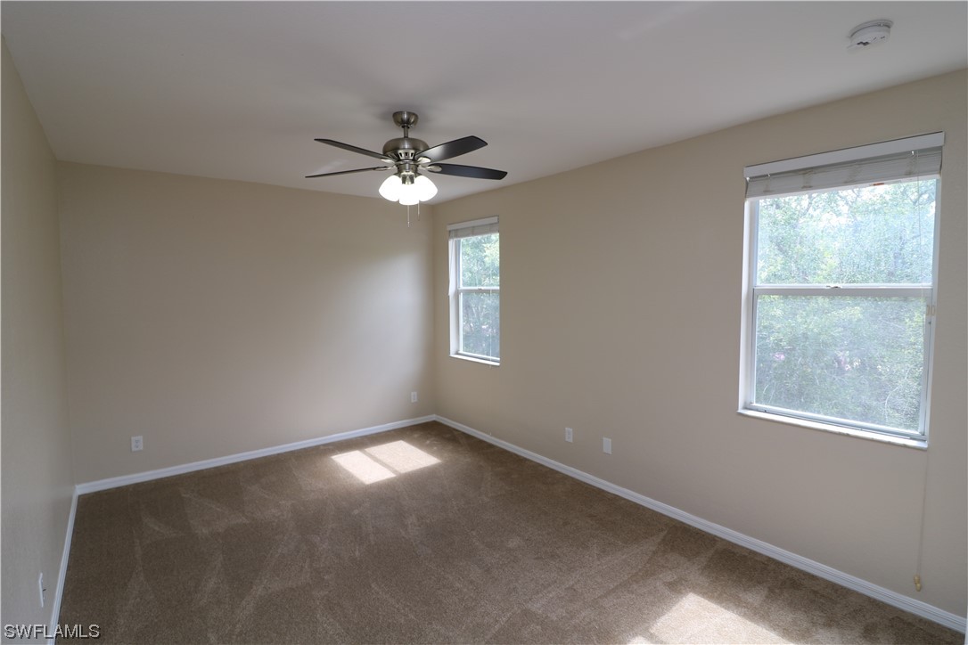 8889 Spring Mountain Way Fort Myers, FL 33908 - Photo 11 of 17 a view of empty room with windows