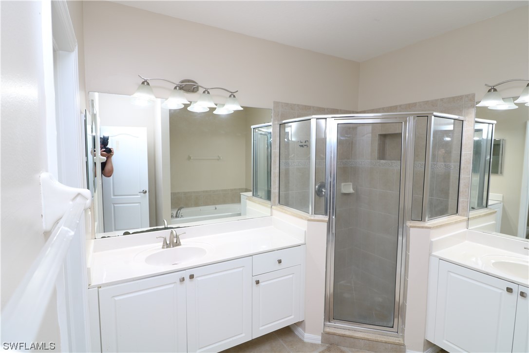 8889 Spring Mountain Way Fort Myers, FL 33908 - Photo 12 of 17 a bathroom with a double vanity sink mirror and shower