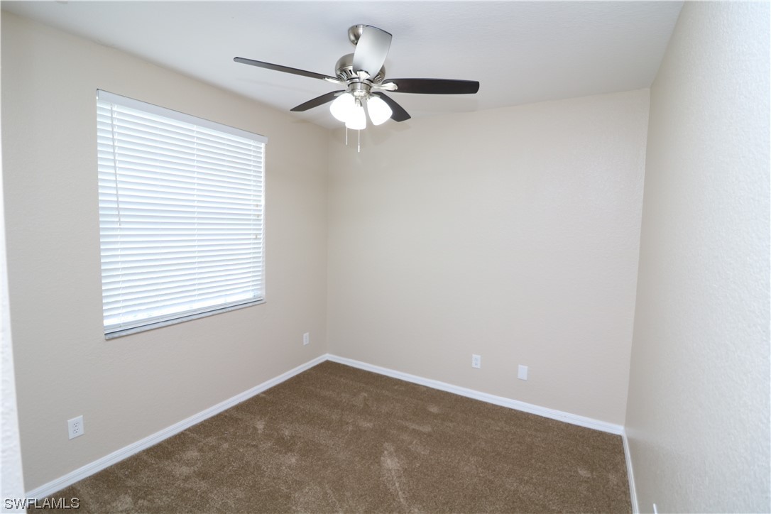 8889 Spring Mountain Way Fort Myers, FL 33908 - Photo 15 of 17 an empty room with a window and a fan