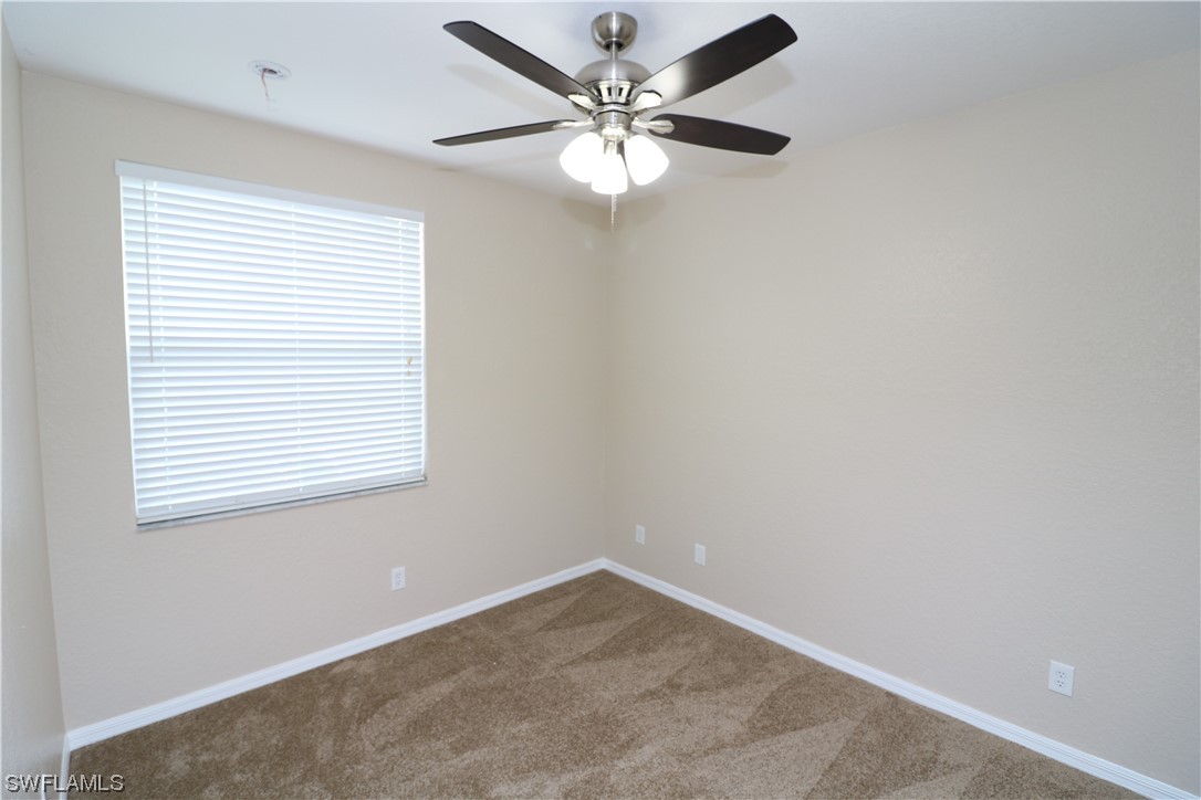 8889 Spring Mountain Way Fort Myers, FL 33908 - Photo 16 of 17 an empty room with a window and a fan