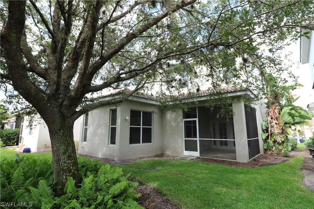 8889 Spring Mountain Way Fort Myers, FL 33908 - Photo 17 of 17 a view of front of a house with a yard