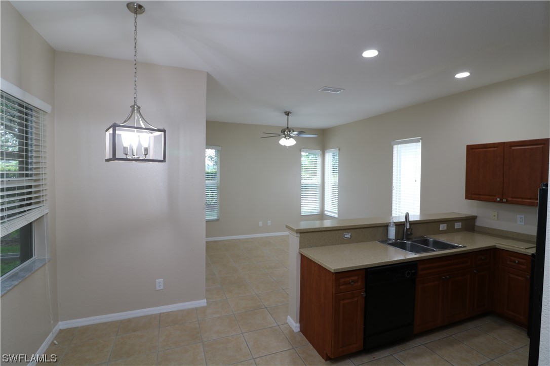 8889 Spring Mountain Way Fort Myers, FL 33908 - Photo 5 of 17 a kitchen with a refrigerator and a sink