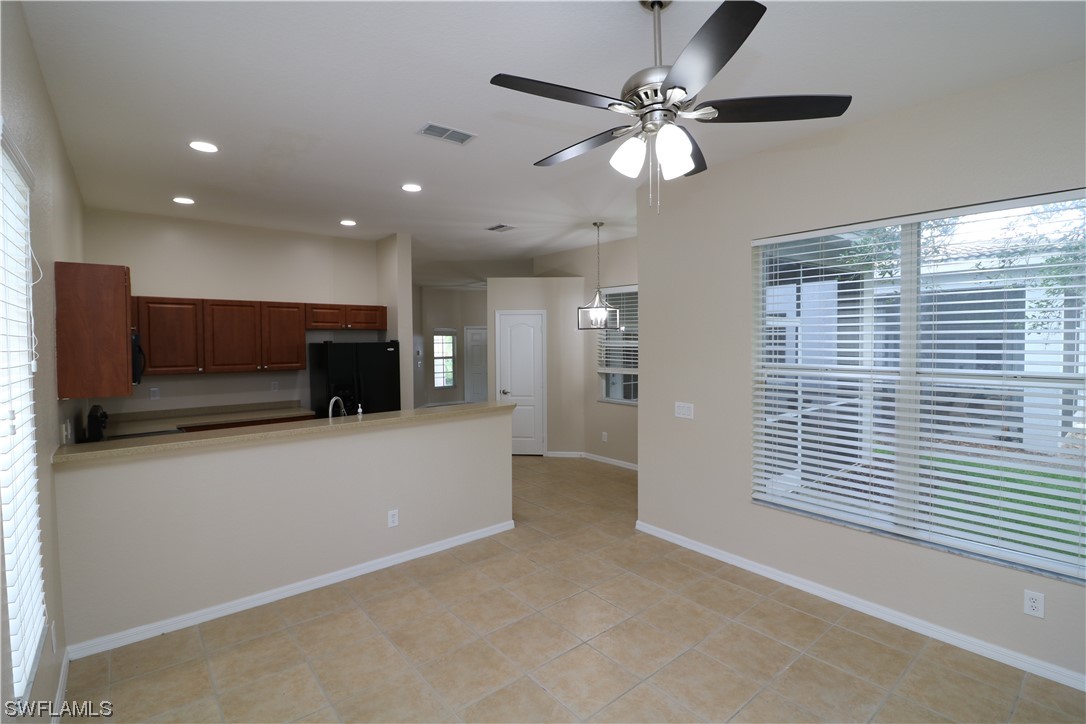 8889 Spring Mountain Way Fort Myers, FL 33908 - Photo 6 of 17 a view of kitchen with furniture and a ceiling fan
