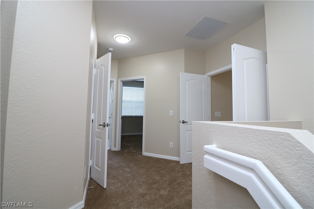 8889 Spring Mountain Way Fort Myers, FL 33908 - Photo 10 of 17 a view of hallway with closet and bathroom