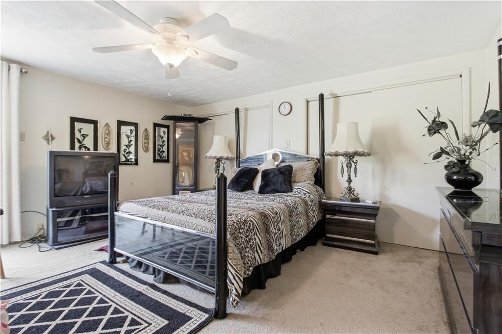 776 Fraction Road West Finley, PA 15377 - Photo 21 of 43 a bedroom with a bed potted plant on dresser and a chandelier