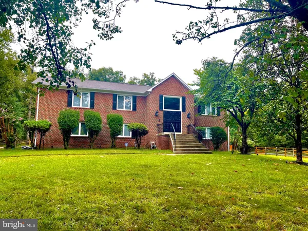 a view of a house with a yard porch and sitting area
