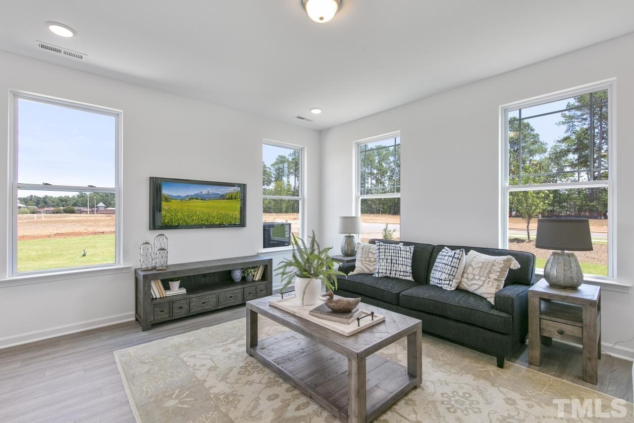 196 Lennei Lane Garner, NC 27529 - Photo 12 of 46 a living room with furniture and a flat screen tv