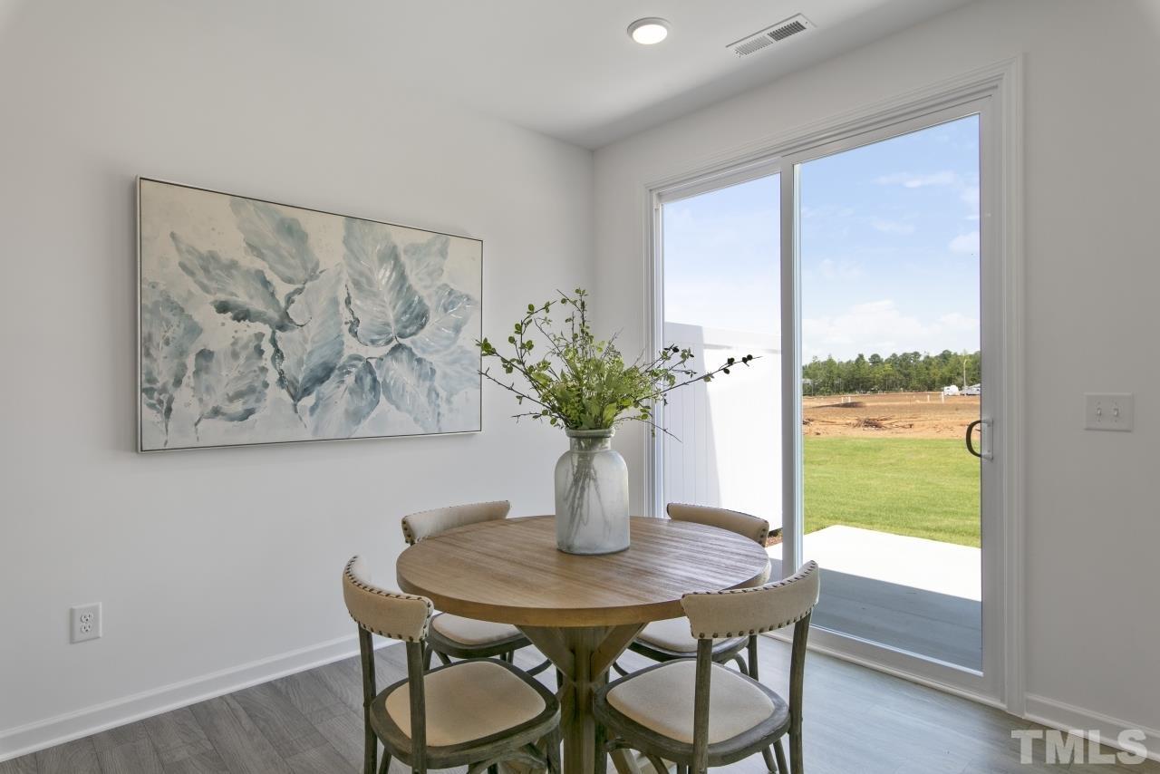 196 Lennei Lane Garner, NC 27529 - Photo 18 of 46 a view of a dining room with furniture window and wooden floor