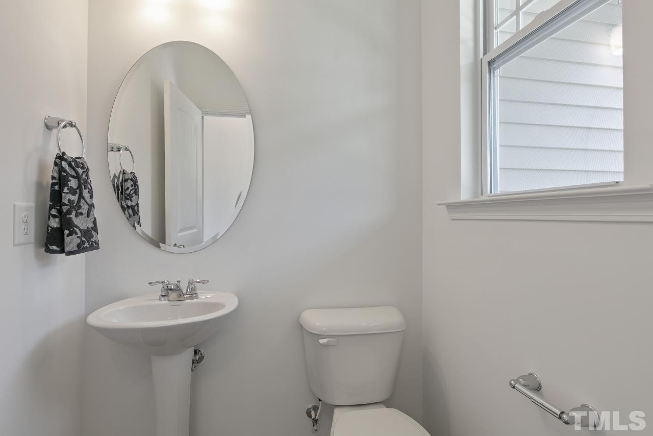 196 Lennei Lane Garner, NC 27529 - Photo 21 of 46 a bathroom with a toilet sink and mirror