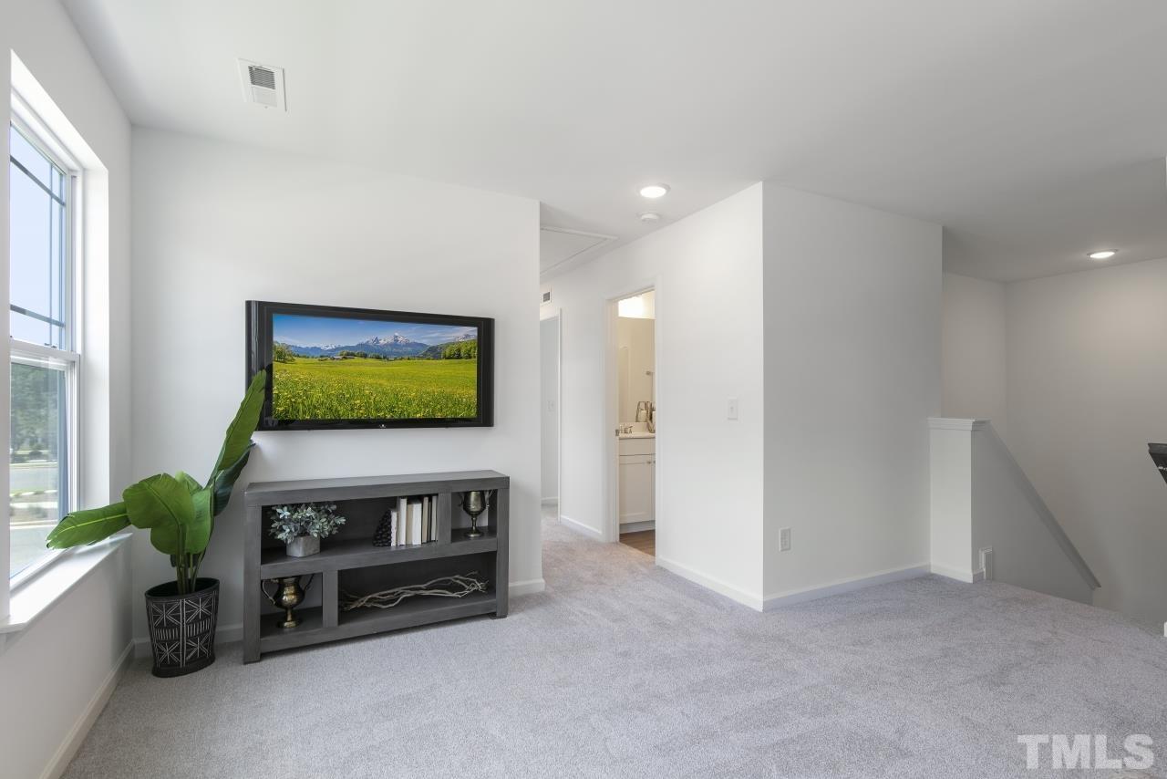 196 Lennei Lane Garner, NC 27529 - Photo 25 of 46 a living room with furniture and a flat screen tv