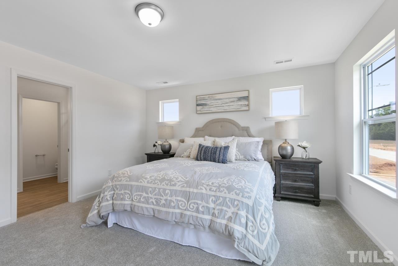 196 Lennei Lane Garner, NC 27529 - Photo 27 of 46 a bedroom with a bed and a window