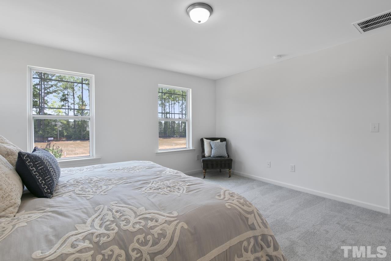 196 Lennei Lane Garner, NC 27529 - Photo 29 of 46 a bedroom with a bed and a window