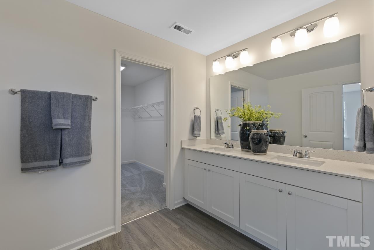 196 Lennei Lane Garner, NC 27529 - Photo 33 of 46 a bathroom with a double vanity sink and mirror
