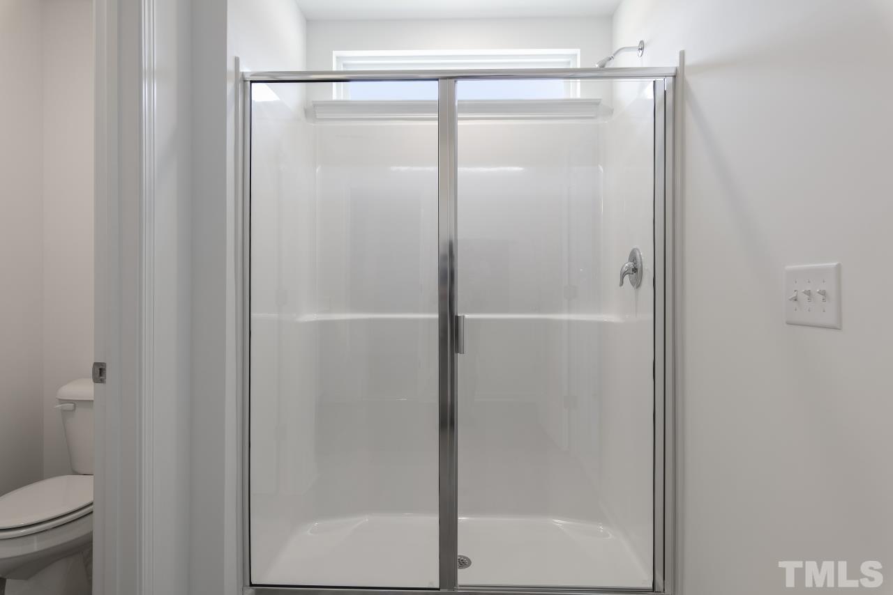 196 Lennei Lane Garner, NC 27529 - Photo 34 of 46 a bathroom with a glass shower door
