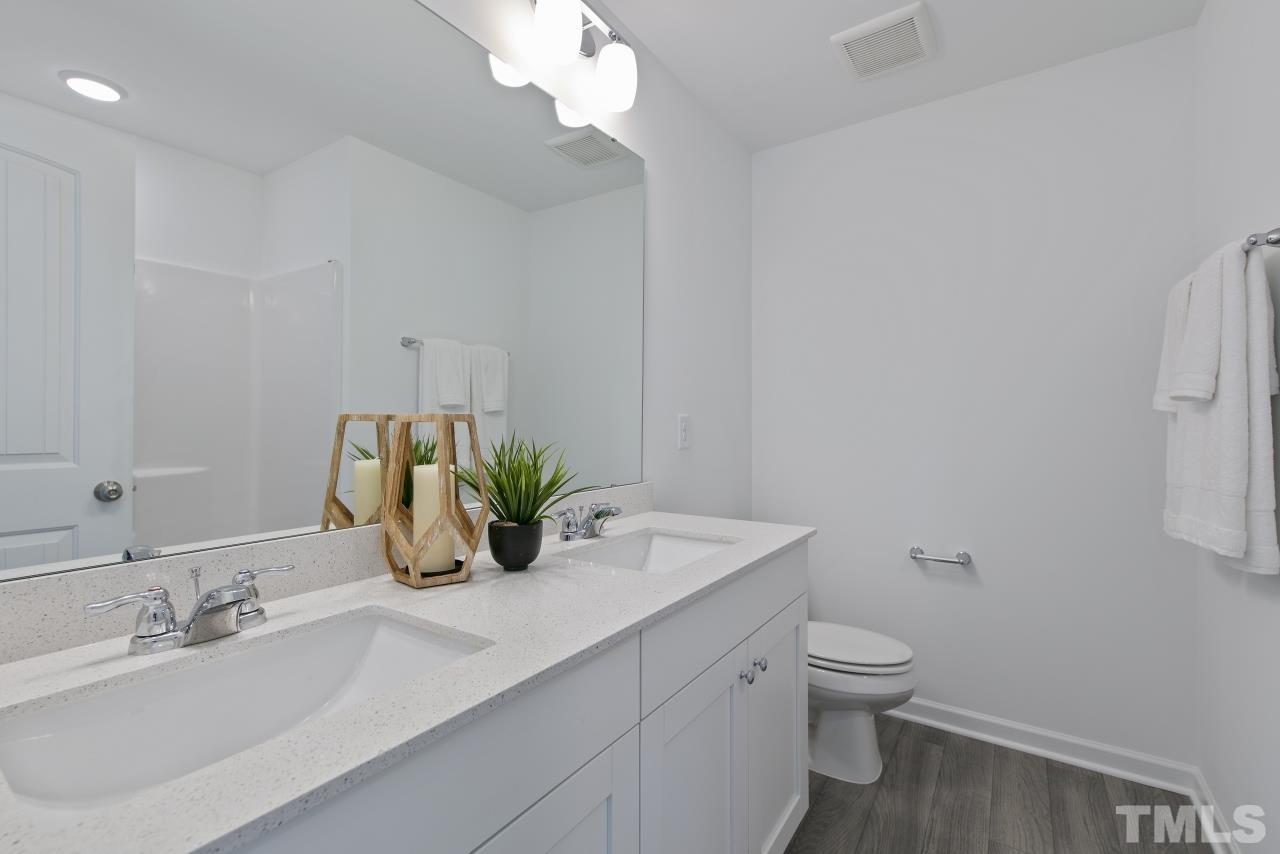 196 Lennei Lane Garner, NC 27529 - Photo 40 of 46 a bathroom with a sink a toilet and a mirror