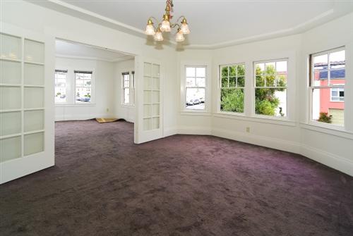 1501-1503 46th Avenue San Francisco, CA 94122 - Photo 4 of 13 an empty room with windows and chandelier fan