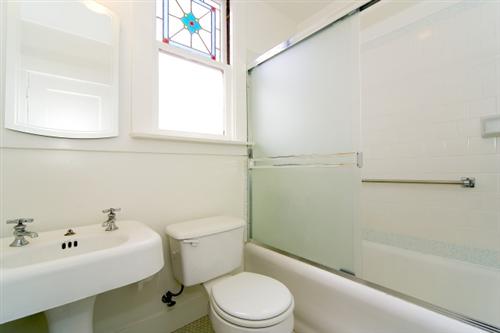 1501-1503 46th Avenue San Francisco, CA 94122 - Photo 7 of 13 a white toilet sitting next to a bath tub