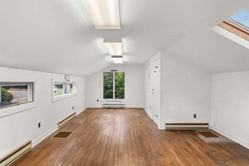 2216 Boston Post Road Darien, CT 06820 - Photo 12 of 31 an empty room with wooden floor and windows