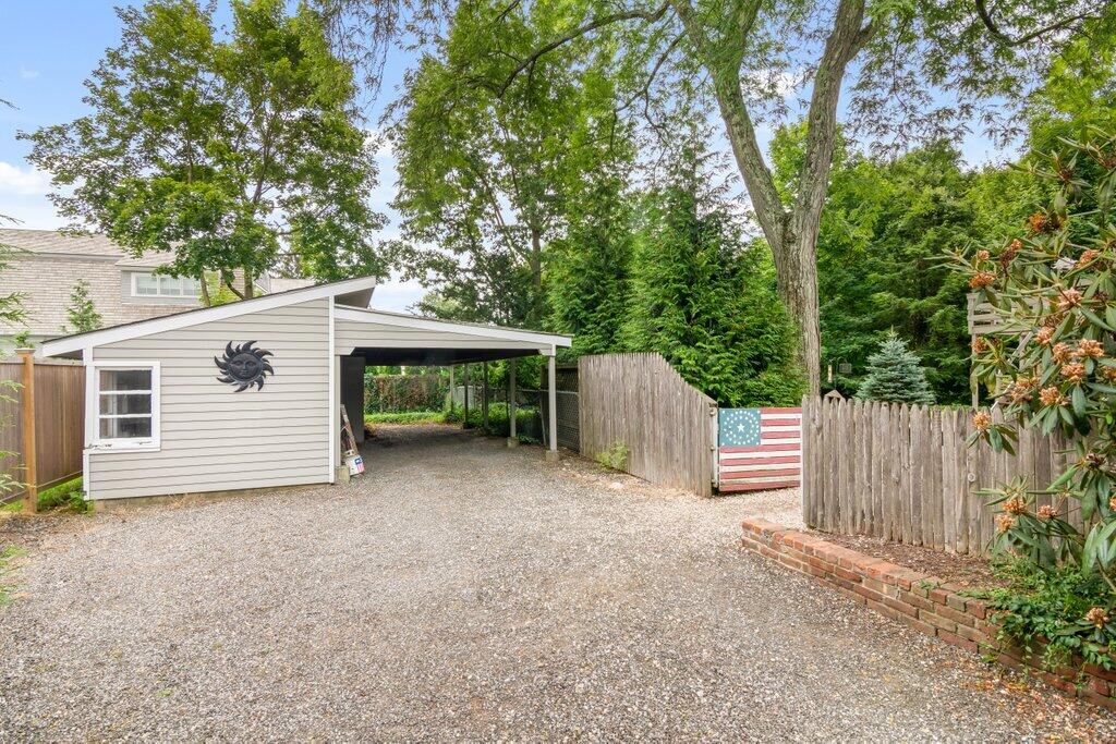 2216 Boston Post Road Darien, CT 06820 - Photo 24 of 31 a view of a house with a small yard and a large tree