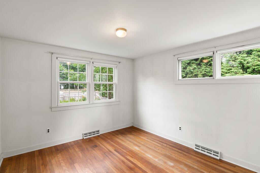 2216 Boston Post Road Darien, CT 06820 - Photo 7 of 31 an empty room with wooden floor and windows