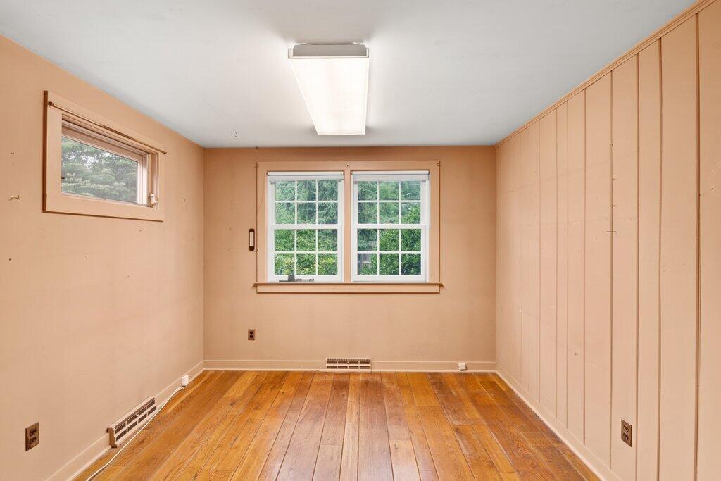 2216 Boston Post Road Darien, CT 06820 - Photo 8 of 31 an empty room with wooden floor and windows