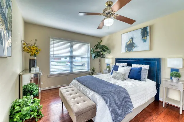 a bedroom with a large bed and a window