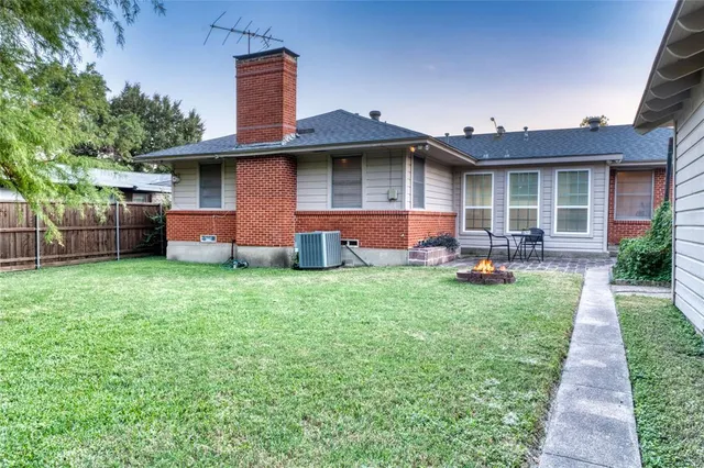 a front view of house with yard and outdoor seating