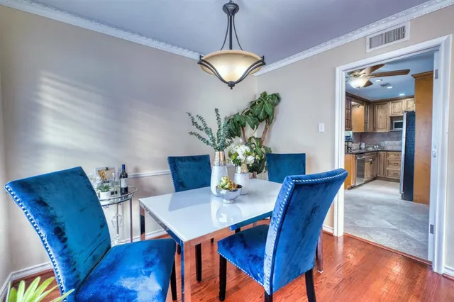 a view of a dining room with furniture wooden floor and a chandelier