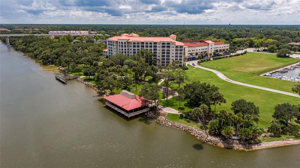 146 Palm Coast Resort Boulevard, Unit 404 Palm Coast, FL 32137 - Photo 1 of 43 an aerial view of a house with a garden and lake view