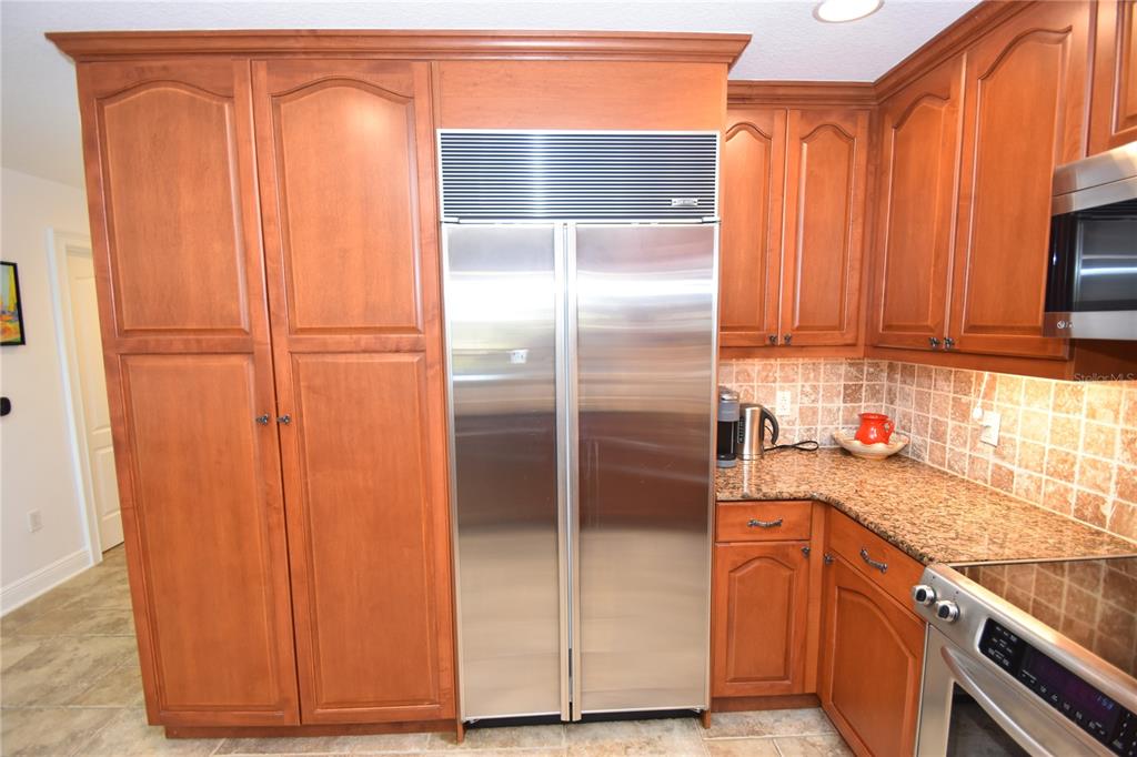 146 Palm Coast Resort Boulevard, Unit 404 Palm Coast, FL 32137 - Photo 11 of 43 a kitchen with a refrigerator a sink and cabinets
