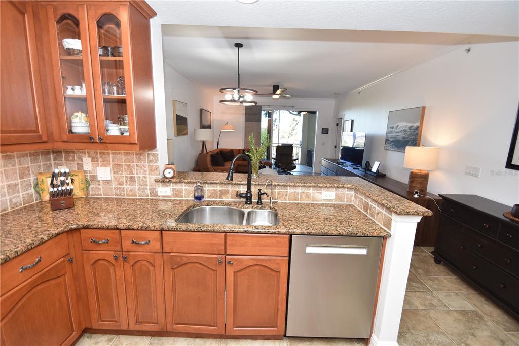146 Palm Coast Resort Boulevard, Unit 404 Palm Coast, FL 32137 - Photo 12 of 43 a kitchen with granite countertop a sink a counter top space and cabinets