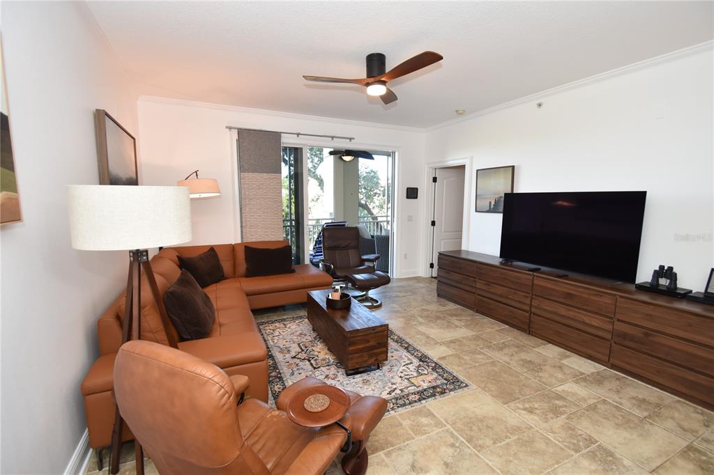 146 Palm Coast Resort Boulevard, Unit 404 Palm Coast, FL 32137 - Photo 18 of 43 a living room with furniture and a flat screen tv