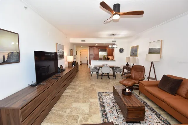 a living room with furniture and a floor to ceiling window
