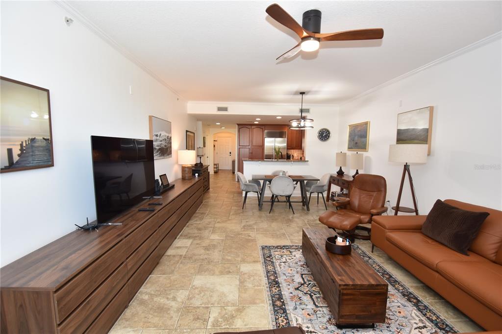146 Palm Coast Resort Boulevard, Unit 404 Palm Coast, FL 32137 - Photo 20 of 43 a living room with furniture and a flat screen tv