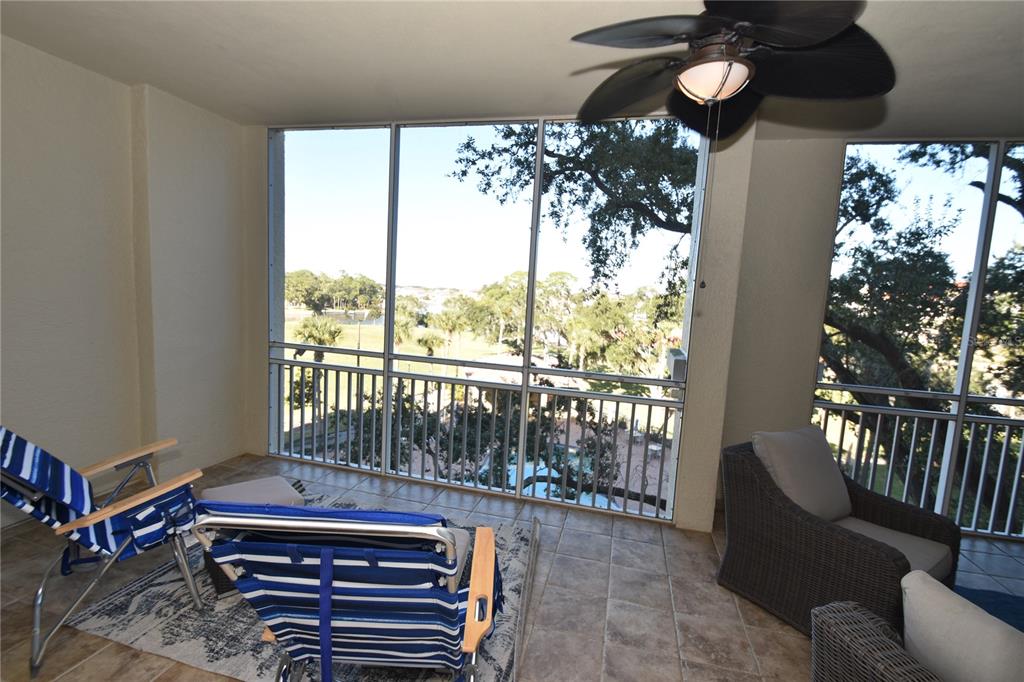 146 Palm Coast Resort Boulevard, Unit 404 Palm Coast, FL 32137 - Photo 22 of 43 a living room with furniture and a floor to ceiling window