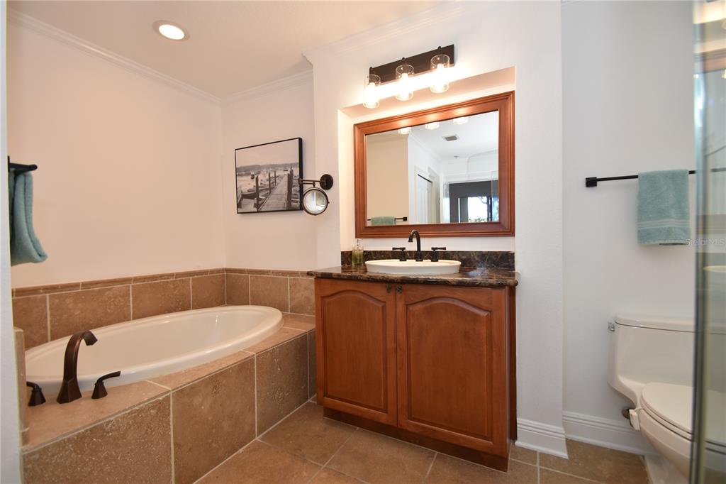 146 Palm Coast Resort Boulevard, Unit 404 Palm Coast, FL 32137 - Photo 29 of 43 a bathroom with a tub a sink and a mirror