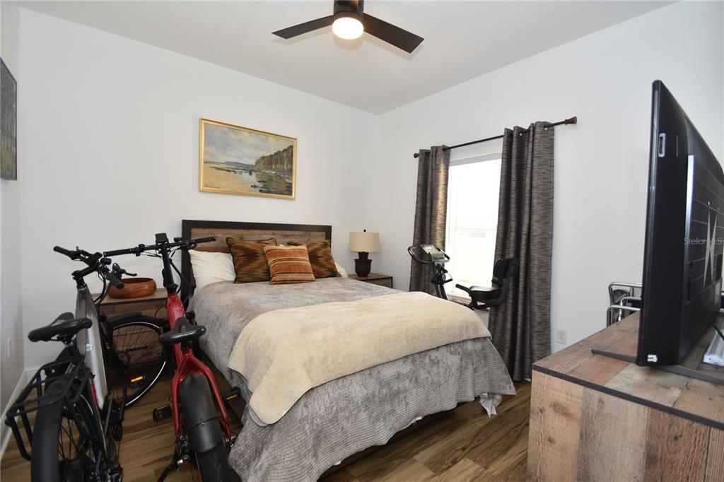 146 Palm Coast Resort Boulevard, Unit 404 Palm Coast, FL 32137 - Photo 33 of 43 a bedroom with a bed and wooden floor