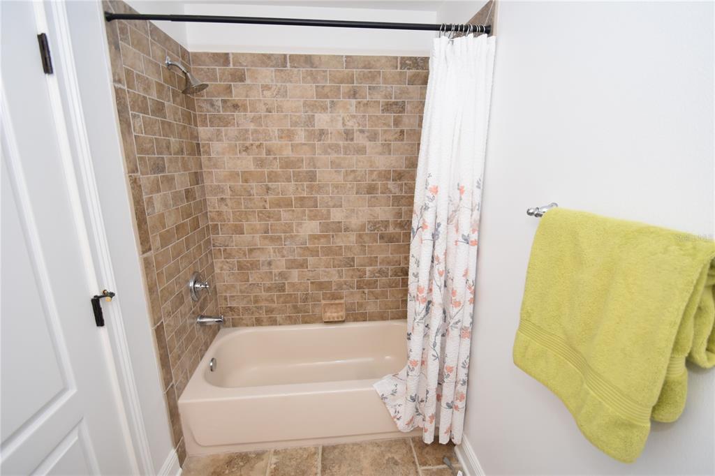 146 Palm Coast Resort Boulevard, Unit 404 Palm Coast, FL 32137 - Photo 35 of 43 a bathroom with a bathtub and a shower