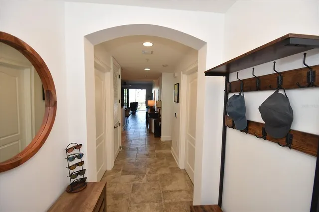 a view of a hallway with wooden floor and entryway