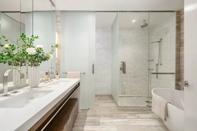 a bathroom with a tub shower sink and toilet