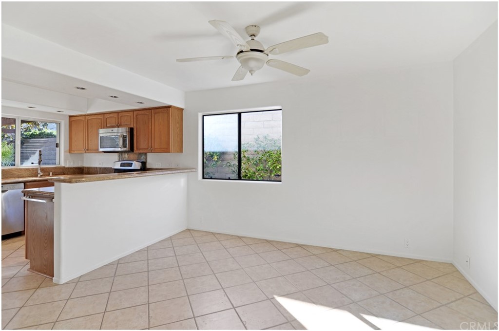 23892 Danzig Bay Dana Point, CA 92629 - Photo 13 of 49 a kitchen with granite countertop a stove a sink and a microwave
