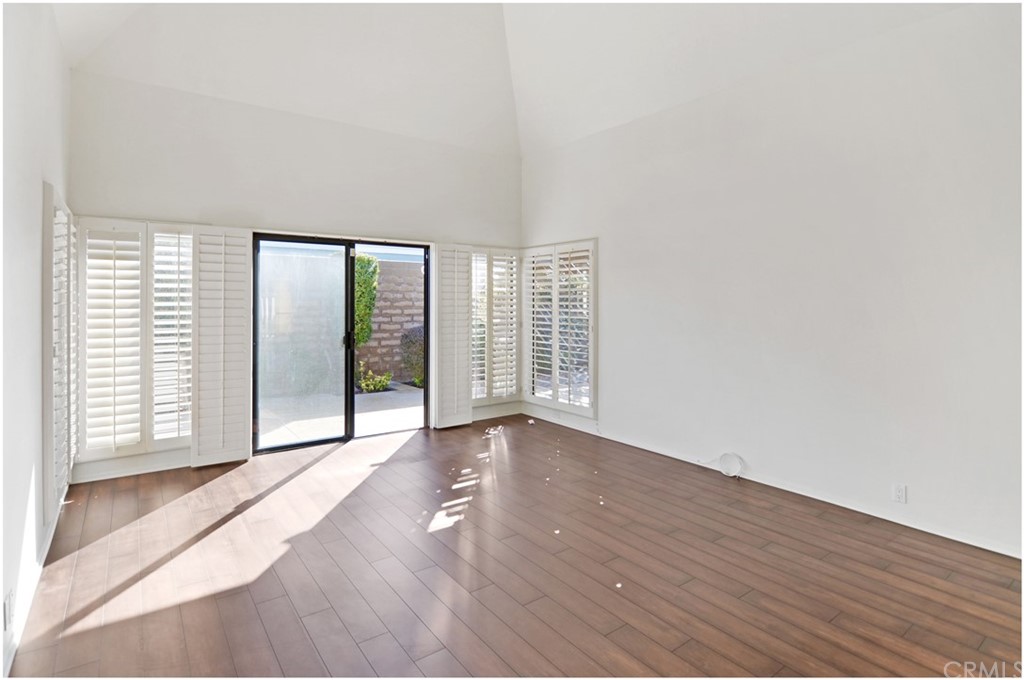 23892 Danzig Bay Dana Point, CA 92629 - Photo 22 of 49 a view of an empty room with wooden floor and a window